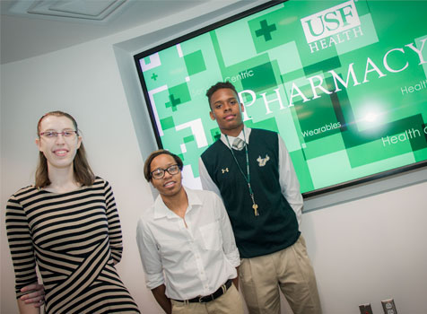 Three student interns from the ֱ Healht College of Pharmacy smile