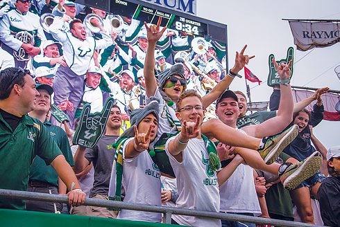 A group of ֱ students cheering in the stands at a ֱ football game at Raymond James Stadium in Tampa, FL.